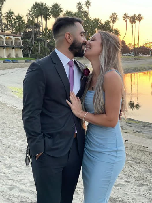 A sunset kiss on the beach, dressed up for a formal evening